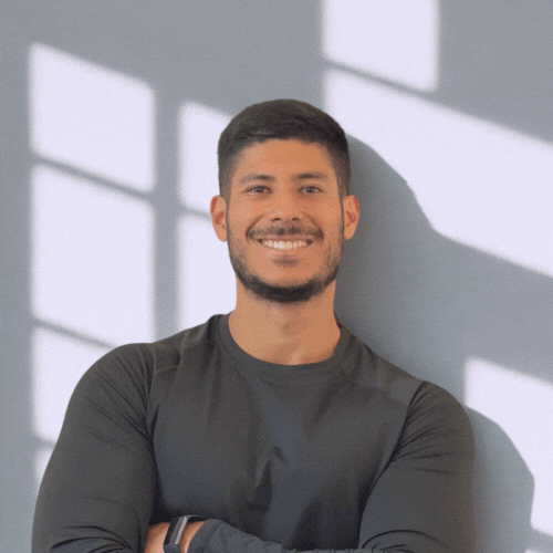 Tefo Fitness trainer smiling confidently with arms crossed, promoting fitness, wellness, and healthy living.